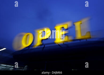 A historic OPEL logo shines on the roof of a car dealer in Cologne, Germany, 17 February 2008. According to Bloomberg news reporting on 17 February 2009 under reference to an insider, US carmaker General Motors (GM) questions closing or selling three plants of its German subsidiary Opel in Europe. German plants Bochum and Eisenach and Belgium?s Antwerpen plant would be affected. GM Stock Photo