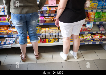 Freiburg, Germany, with two women in front of a shelf sweets Stock Photo