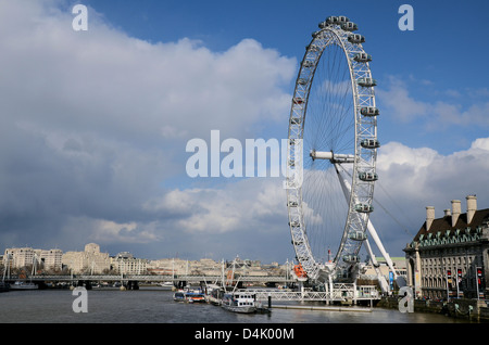 The EDF London Eye on the South Bank of the river Thames in London against a blue sky with light clouds. Millennium Wheel Stock Photo