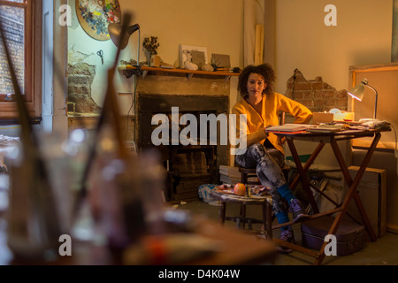 Woman reading at desk Stock Photo