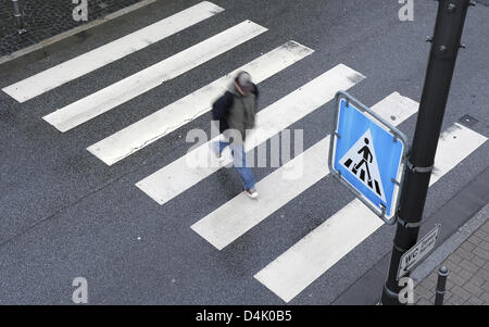 The picture shows a pedestrian walking on a zebra crossing in Heidelberg, Germany, 06 March 2009. Photo: Ronald Wittek Stock Photo