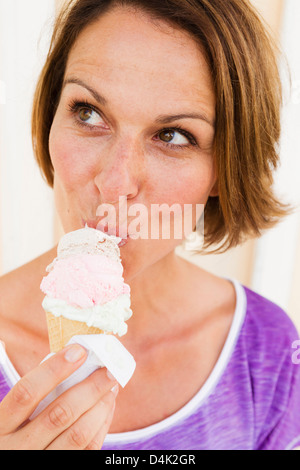 Close up of woman eating ice cream cone Stock Photo