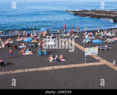 The beach of  Playa La Arena a resort town on the west coast of Tenerife. Black lava sand,  views of  open sea Stock Photo