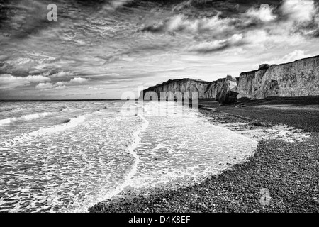 Waves washing up on rocky beach Stock Photo