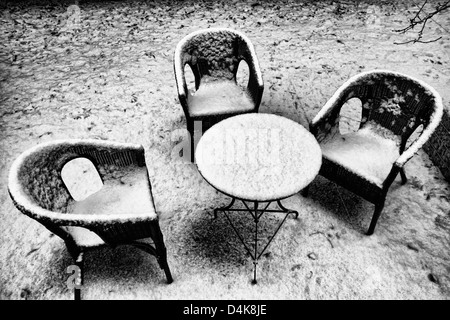 Chairs and table in snowy backyard Stock Photo