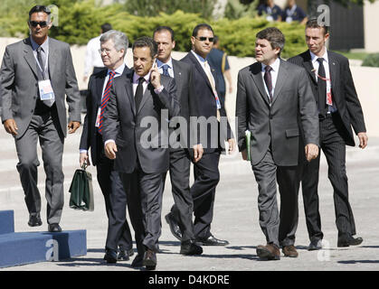 French President Nicolas Sarkozy (3-L) speaks on his phone as he arrives for a round table meeting of the G8 with the G5 and Egypt at the G8 Summit in L?Aquila, Italy, 09 July 2009. Leaders of the exclusive club of eight industrialized nations open up their forum on 09 July to the five fastest developing market economies (G5) in which they will discuss the economy, climate change a Stock Photo
