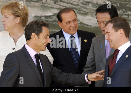 (L-R) German Chancellor Angela Merkel, French President Nicolas Sarkozy, Italian Prime Minister Silvio Berlusconi, Japanese Prime Minister Taro Aso, and Russian President Dmitri Medvedev line up for a group photo of the G5 and G8 leaders at the G8 Summit in L?Aquila, Italy, 09 July 2009. On the second day, leaders of the exclusive club of eight industrialized nations open up their  Stock Photo