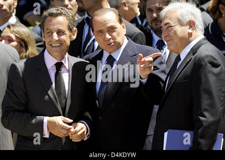 (L-R) French President Nicolas Sarkozy, Italian Prime Minister Silvio Berlusconi, and Dominique Strauss-Kahn, Managing Director of the International Monetary Fund (IMF) line up for a group photo at the G8 Summit in L?Aquila, Italy, 09 July 2009. On the second day, leaders of the exclusive club of eight industrialized nations open up their forum on 09 July to the five fastest develo Stock Photo