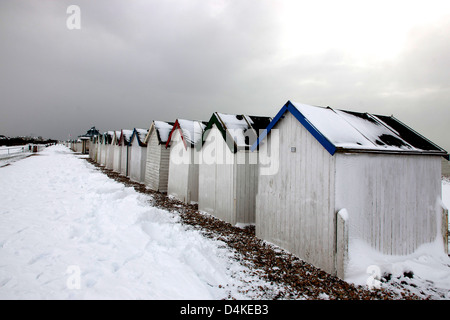 Snow at Beach Huts at Goring West Sussex UK Stock Photo