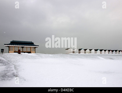 Snow at Beach Huts at Goring West Sussex UK Stock Photo