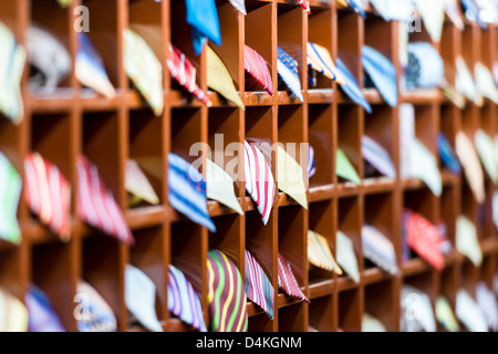 Rows of new colorful ties on shelves at shop. Great section of ties in different colors. Big choice of apparel or business style Stock Photo