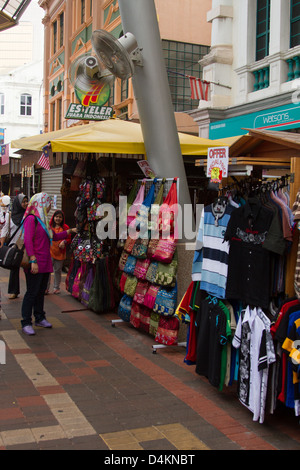 woman looking at handbags on stall in central market Kuala lumpur Stock Photo