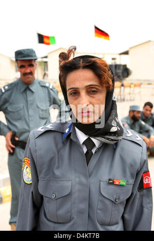 The only woman among the 55 police officers participates in the ceremony on the occasion of the successful completion of a two-month training at the Police Training Center Mazar E Sharif, Afghanistan, 19 May 2009. The police aspirants from the district of Deh Dadi were trained by the German police and ISAF military police. Afterwards, the officers will return to their districts to  Stock Photo