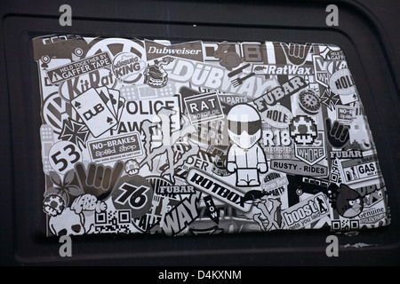stickers on vehicle window of Vauxhall Rascal van parked in car park at Mudeford Quay, Dorset UK  in March - black and white, black & white monochrome Stock Photo