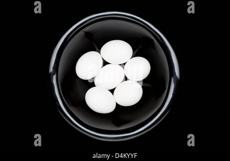 White eggs in black bowl Stock Photo