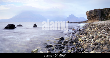 A view of the Cuillin Hills across Cuillin Sound from a pebbly Elgol Bay on the Isle of Skye Stock Photo
