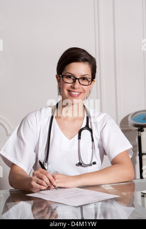 Doctor taking notes in office Stock Photo