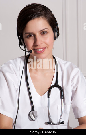 Doctor talking on headset in office Stock Photo