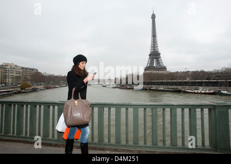 Woman using cell phone on city street Stock Photo