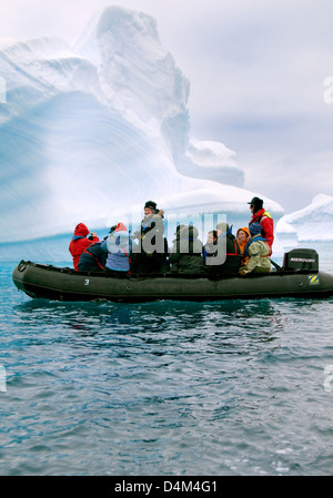 Tourists cruising among icebergs in Antarctica