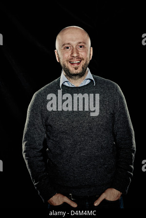 Smiling man with hands in pockets Stock Photo