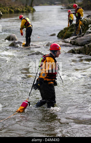 Swiftwater and Flood Rescue Technician course. Trainee Firemen at Devil's Bridge in Kirby Lonsdale, England Friday 15th March, 2013.  Members of the Barrow-in-Furnace and Kendal Swiftwater and Flood Rescue Technician course. Fire Service Rescue Unit, wearing Petzl safety helmets and Rescue 800 PFD Bouyancy Aid with Aqua-Tek X480 Scuba Diving Dry Suit, undergoing annual flood & Swift Water Rescue 3 Training on the River Lune at Kirby Lonsdale, Cumbria, UK. Stock Photo