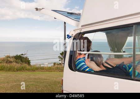 Couple relaxing together in trailer Stock Photo