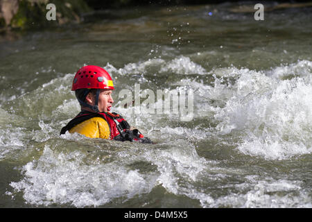 Swiftwater and Flood Rescue Technician course. Trainee Firemen at Devil's Bridge in Kirby Lonsdale, England Friday 15th March, 2013.  Members of the Barrow-in-Furnace and Kendal Swiftwater and Flood Rescue Technician course. Fire Service Rescue Unit, wearing Petzl safety helmets and Rescue 800 PFD Bouyancy Aid with Aqua-Tek X480 Scuba Diving Dry Suit, undergoing annual flood & Swift Water Rescue 3 Training on the River Lune at Kirby Lonsdale, Cumbria, UK. Stock Photo