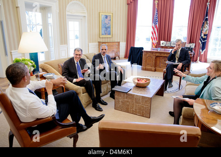 US President Barack Obama meets with Solicitor General Donald Verrilli, left, and Attorney General Eric Holder in the Oval Office February 21, 2013 in Washington, DC. Chief of Staff Denis McDonough and Kathryn Ruemmler, Counsel to the President, join them. Stock Photo