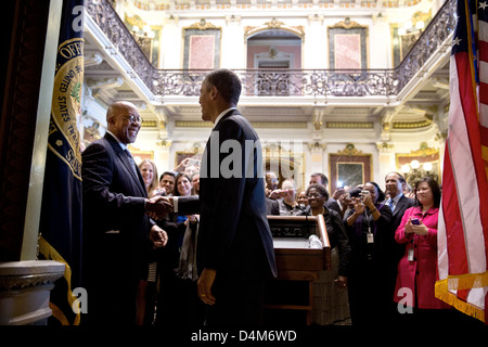 US President Barack Obama drops by a farewell reception for US Trade Representative Ron Kirk in the Indian Treaty Room of the Eisenhower Executive Office Building at the White House February 25, 2013 in Washington, DC. Stock Photo