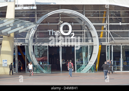 People at O2 multi purpose indoor arena building & entrance with large logo sign at millennium dome North Greenwich Peninsula London England UK Stock Photo