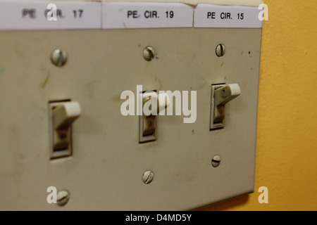 light switches close up with yellow wall Stock Photo