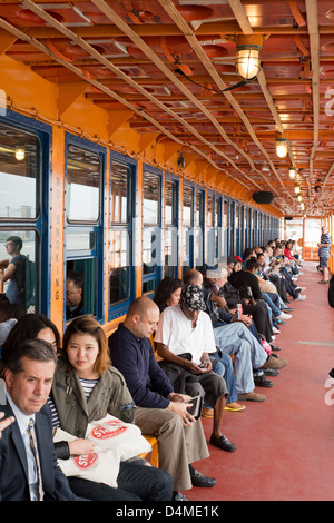 People traveling on the Staten Island Ferry. Stock Photo