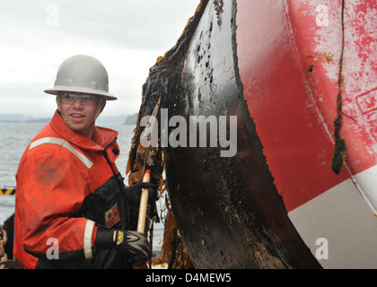 Fireman Boyle scrapes away Stock Photo