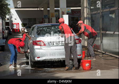 Hand car wash business washing and drying a vehicle Stock Photo