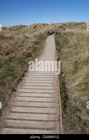 The Wales Coastal Path in North Wales. The boardwalk on Talacre sand dunes and beach on the north coast of Wales. Stock Photo