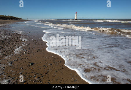 The Wales Coastal Path in North Wales. Picturesque view of Talacre beach at high tide with the lighthouse in the background. Stock Photo