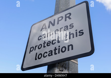 Sign in an industrial area warning that Automatic Number Plate Recognition (ANPR) cameras are in use to protect this location. Stock Photo