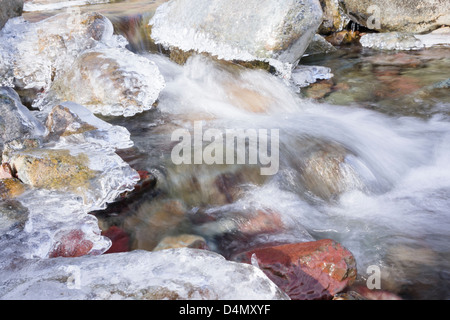 Spring sunshine slowly thaws the frozen streams in the Lake District Stock Photo