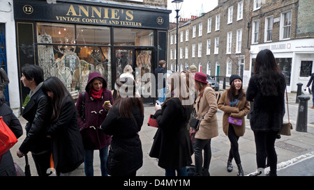 Customers queuing on a cold March Saturday for a seat in a popular restaurant in Camden Passage, Islington London N1 England UK Stock Photo