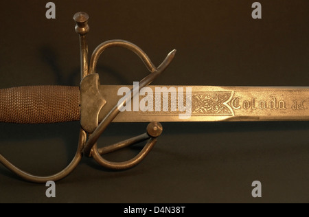 studio photography of a old corroded sword detail with decorations in warm light Stock Photo