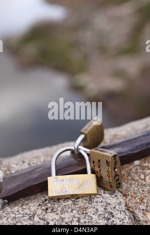 Love Locks Padlocks locked onto a bridge over a river with love messages Toledo Spain Stock Photo