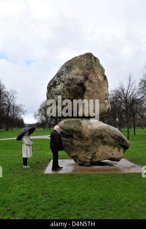 A couple looking at a huge sculpture in Kensington Gardens, London, UK. Stock Photo
