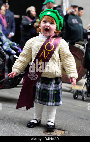 March 16, 2013 - New York, NY, U.S. - Wee GRACE TAYLOR, 20 months old redhead girl, smiles with joy as she finishes Irish jig before marching in 252nd annual NYC St. Patrick’s Day Parade with the Iona College, New Rochelle, NY, group. Marchers showed their Irish pride, as they march up Fifth Avenue. Stock Photo