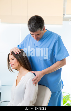 physiotherapist doing myofascial therapy on woman patient in hospital Stock Photo