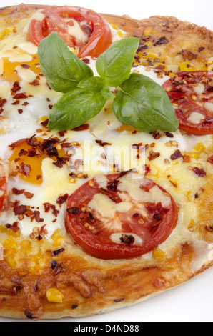 pizza with fried egg, basil and tomato Stock Photo