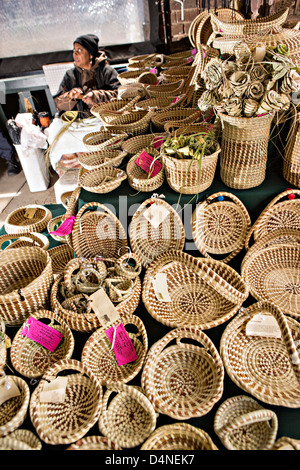 Gullah woman weaving sweetgrass baskets at the Historic Charleston City Market on Market Street in Charleston, SC. Stock Photo