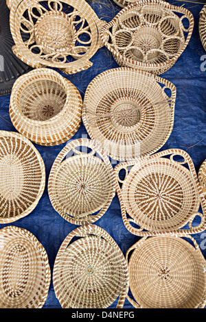 Gullah woman weaving sweetgrass baskets at the Historic Charleston City Market on Market Street in Charleston, SC. Stock Photo