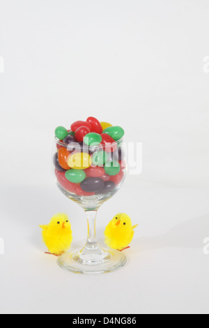 Wine glass filled with candies of different colors Stock Photo
