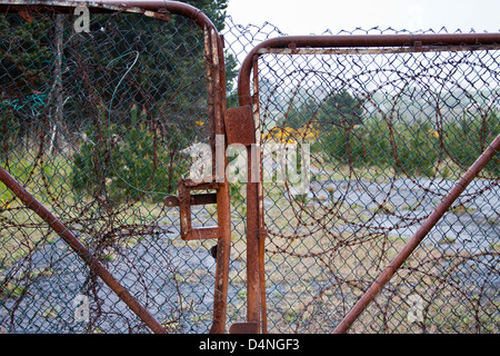 Rusty gate and barbed wire Stock Photo